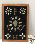 Framed vintage collection of stone caved arrowheads and South American ceramic faces