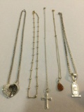 Selection of five Sterling silver necklaces with silver pendants, one with amber pendant