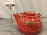 Vintage cast iron teapot painted red w/ lid and metal handle, approx 10 x 6 in.