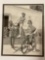 Framed antique B&W photo of girls on bikes, approx 14 x 17 in.