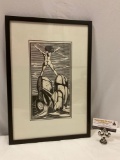 Framed art print of nude figure on rocks in facing ocean, approx 13 x 19 in.