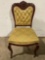 Antique wood carved chair w/ upholstery/ 2 wheels, face carving, approx 19 x 18 x 36 in.