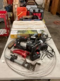 Table full of miscellaneous, drill and chargers, pipe clamp, Greenwood propane torch, plus items