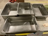 Set of three stainless steel warming trays and a strainer tray