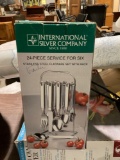 Still new in box/24 piece stainless steel flatware set with rack/great for a travel trailer