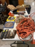 Table full of assorted tools, tiedowns, rope, large heavy duty electric cord,Find splitting wedges