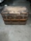 Antique wooden steamer trunk with brass detail, missing one leather handle