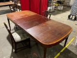 Large solid wood dining table with 2 leaves and 3 matching chairs.