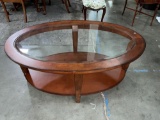 Elegant solid wood oval shaped coffee table with beveled glass top