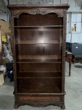 Stately and ornate solid wood bookcase with adjustable shelves and lower drawer