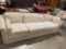 Vintage mid century cream colored couch , on rollers sold as is see pics