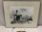 Framed vintage black and white photograph of crew of rugged pioneers posing in camp