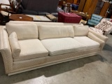 Vintage mid century cream colored couch , on rollers sold as is see pics