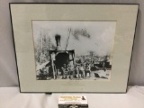 Framed vintage black and white photograph of crew of rugged pioneers posing in camp