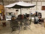 outdoor metal patio table w/ 4 metal rocking chairs ,cushions and an umbrella