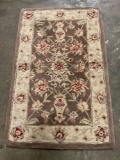 Smaller brown wool rug in good condition.