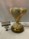 Vintage brass / ceramic lamp w/ cherub design, tested/working, approx 6 x 9.5 in.