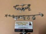 2 fancy sterling silver charm bracelets with many adorable charms. Approx weight 60 g.