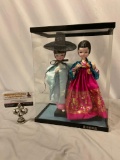 Pair of Asian dolls in display case, approx 9 x 6 x 12 in.