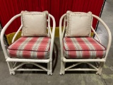 Pair of wood and rattan chairs with cushions and pillows