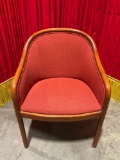 Vintage upholstered barrel chair in orange/rust color