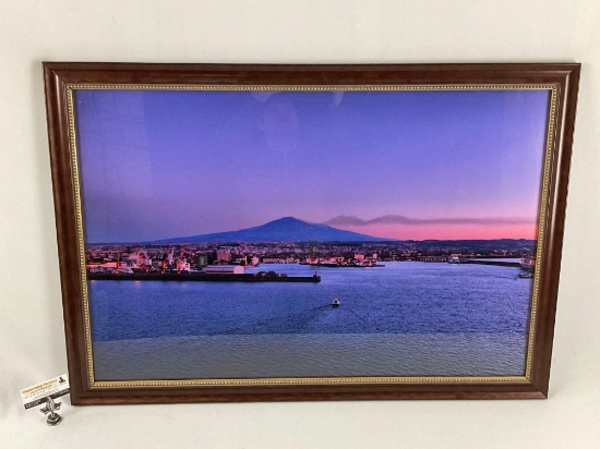 Framed color photograph of sunrise over port, approx 40 x 28 in.