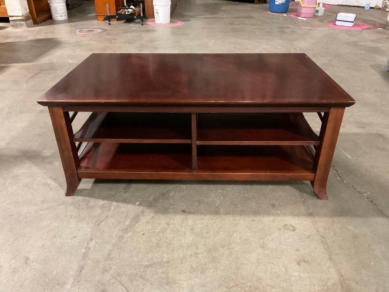 Rectangular wooden coffee table with shelf storage.