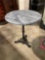 Beautiful beveled stone top circular table with cast iron base.