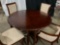 CHERRY WOODROUND CUSTOM DINING TABLE WITH SET OF 6 CHAIRS AND CUSTOM LEAVES.