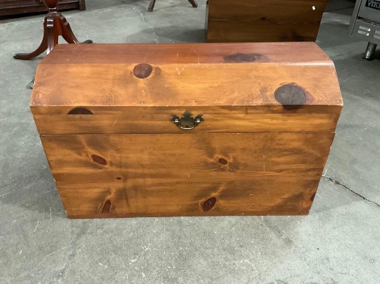 Vintage wooden chest with knotty grain pattern.