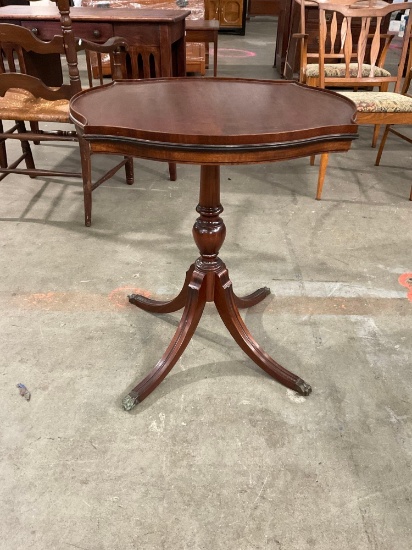 Beautiful vintage Raised-edge pedestal table with metal-capped claw feet.