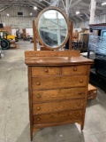 Vintage Tiger Oak dresser with floating beveled glass oval mirror.