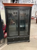Large lighted display / curio cabinet with storage drawers.
