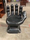 Unique Black molded plastic hand chair.