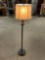 Smaller metal floor lamp with off-white shade in good condition.