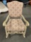 Vintage whitewashed wooden floral upholstered rocking chair.