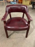 Burgundy leather(?) upholstered arm chair with nailhead trim accents.