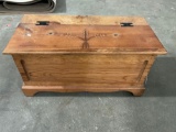 Cute solid wood storage trunk with grain design carved on top.
