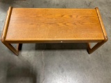 Wooden coffee table with beveled edge legs.