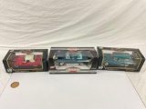 collection of 3x American Muscle and Road Tough 1/18 scale die cast cars in original boxes.