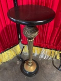 Vintage pedestal with unique center brass style with black top.