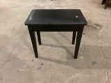 Little bench with storage and padded cushion.