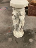 Pedestal with figures holding up standing around the center.