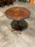 Antique wooden hexagonal table from GREGORY Furniture Co. Inlay design on top, shows wear.