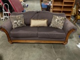 Nice Large Eggplant upholstered loveseat with rolled arms and 3 pillows.