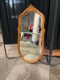 Wood frame mirror with beveled glass edges.