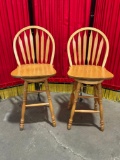 Nice pair of solid Oak swiveling bar stools with backs.