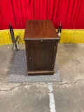 Vintage wooden side table with pullout extension in front.