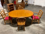 Oval Oak Dining Table with one leaf and 4 chairs.