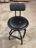 Barstool with adjustable base and padded cushion on seat and backrest.